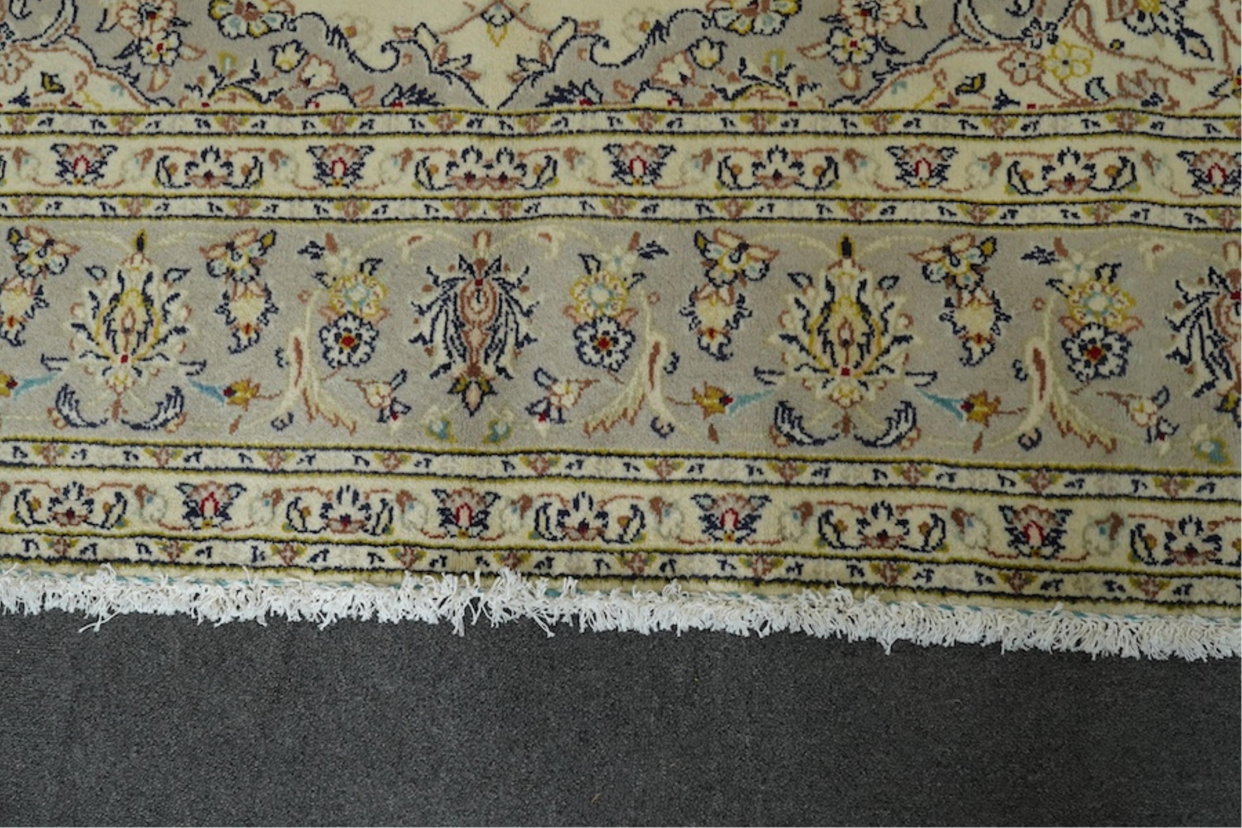 A Kashan ivory ground carpet, 300 x 195cm. Condition - good